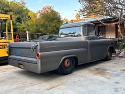 The grey Apache outdoors, viewed from the rear.