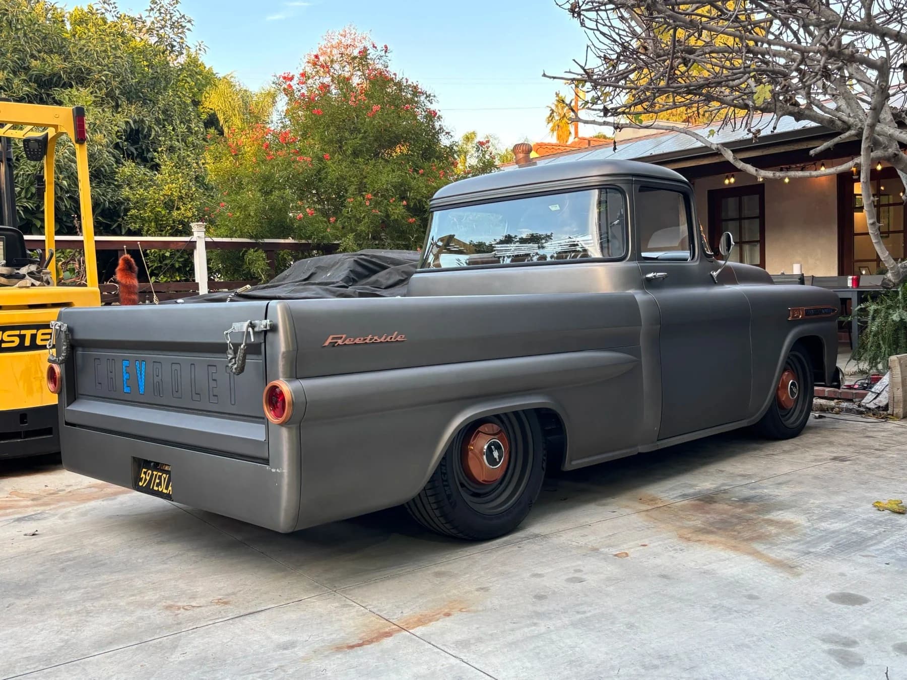 The grey Apache outdoors, viewed from the rear.