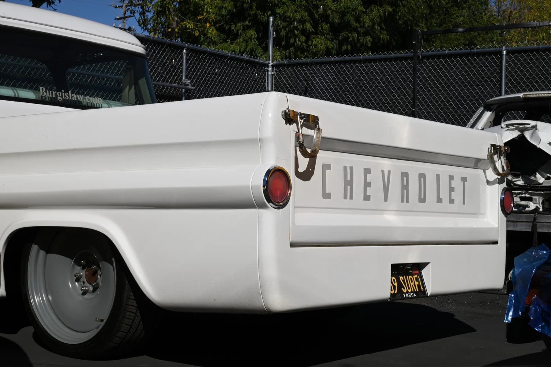 Rear three-quarter view of the white Apache.