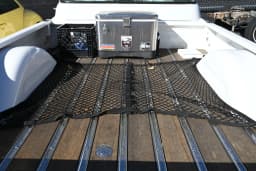 The pickup bed and wood floor.