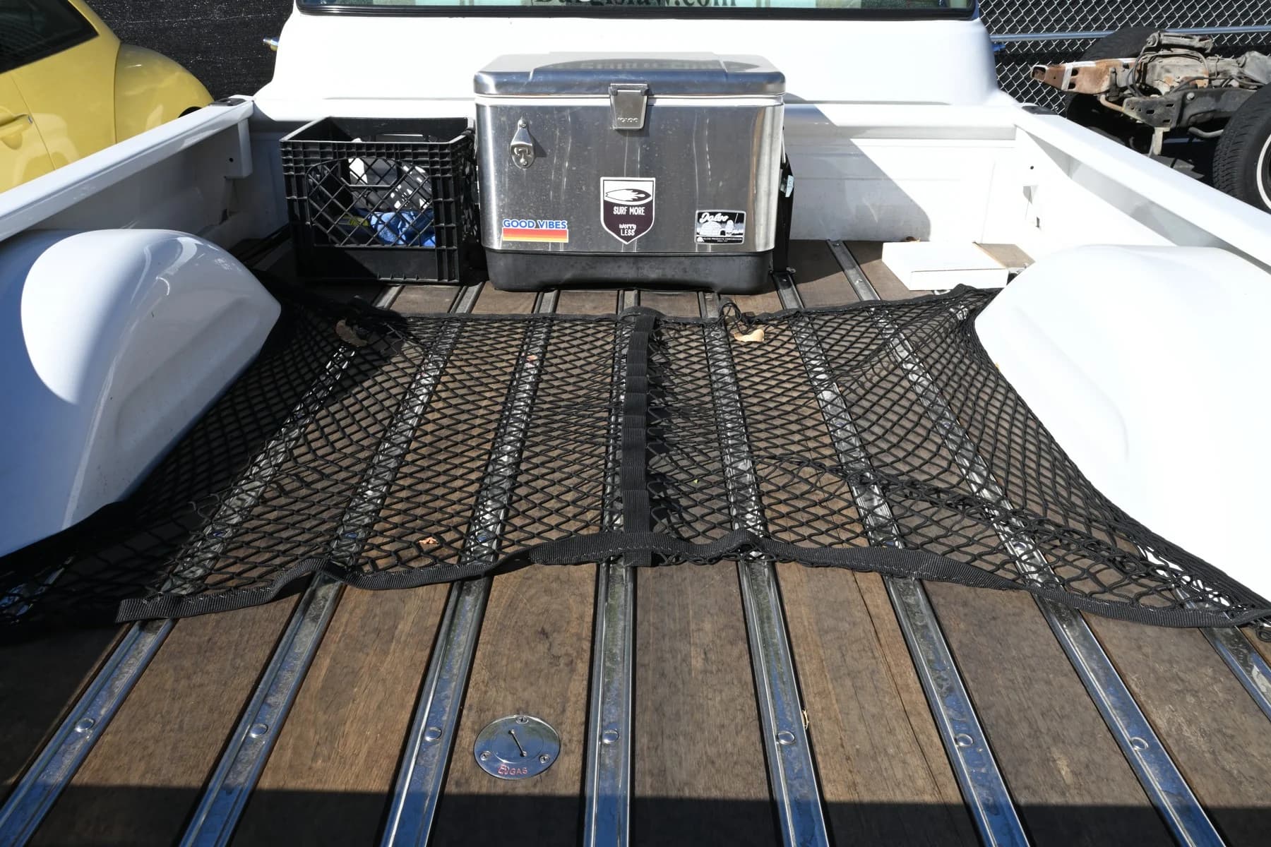The pickup bed and wood floor.