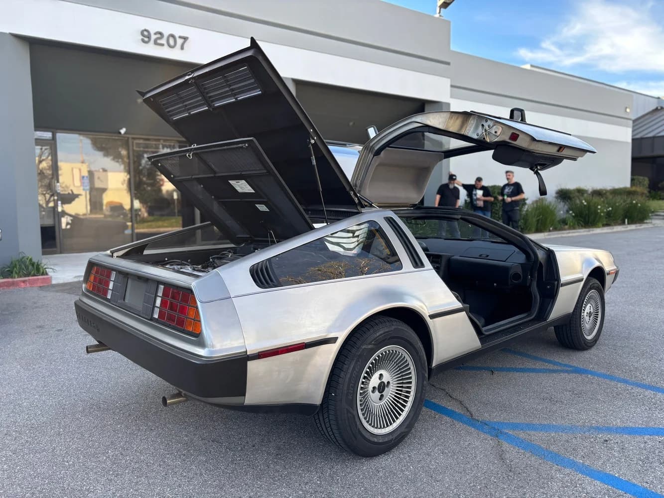 The actual DeLorean with its gullwing doors open.