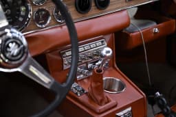 Wood dashboard, leather trim, and center-console details.