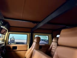 Seats and cabin finishing in the tan Humvee.