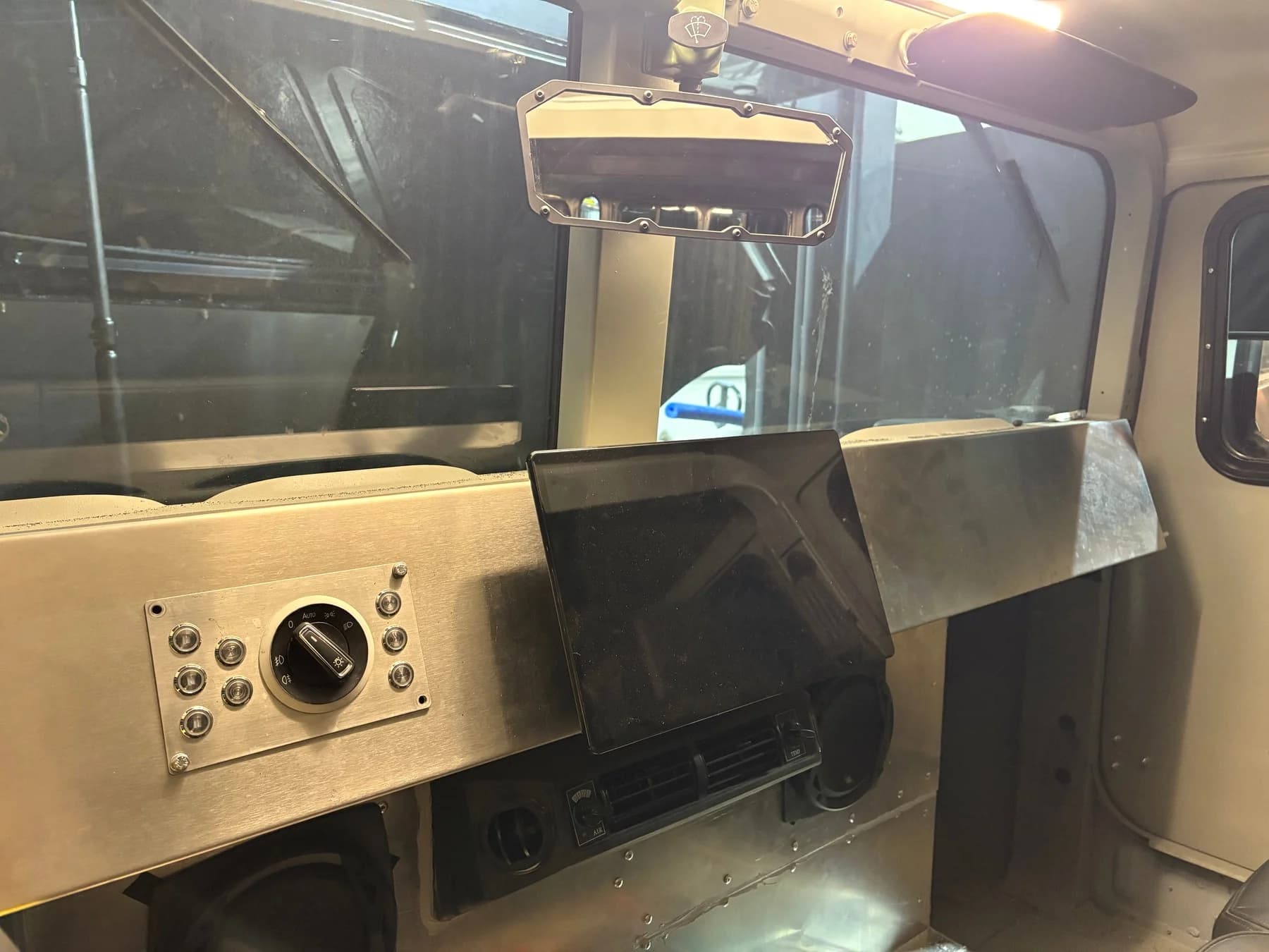 Dashboard and control work in the grey Humvee.