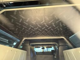 Roof-insulation work in the grey Humvee.