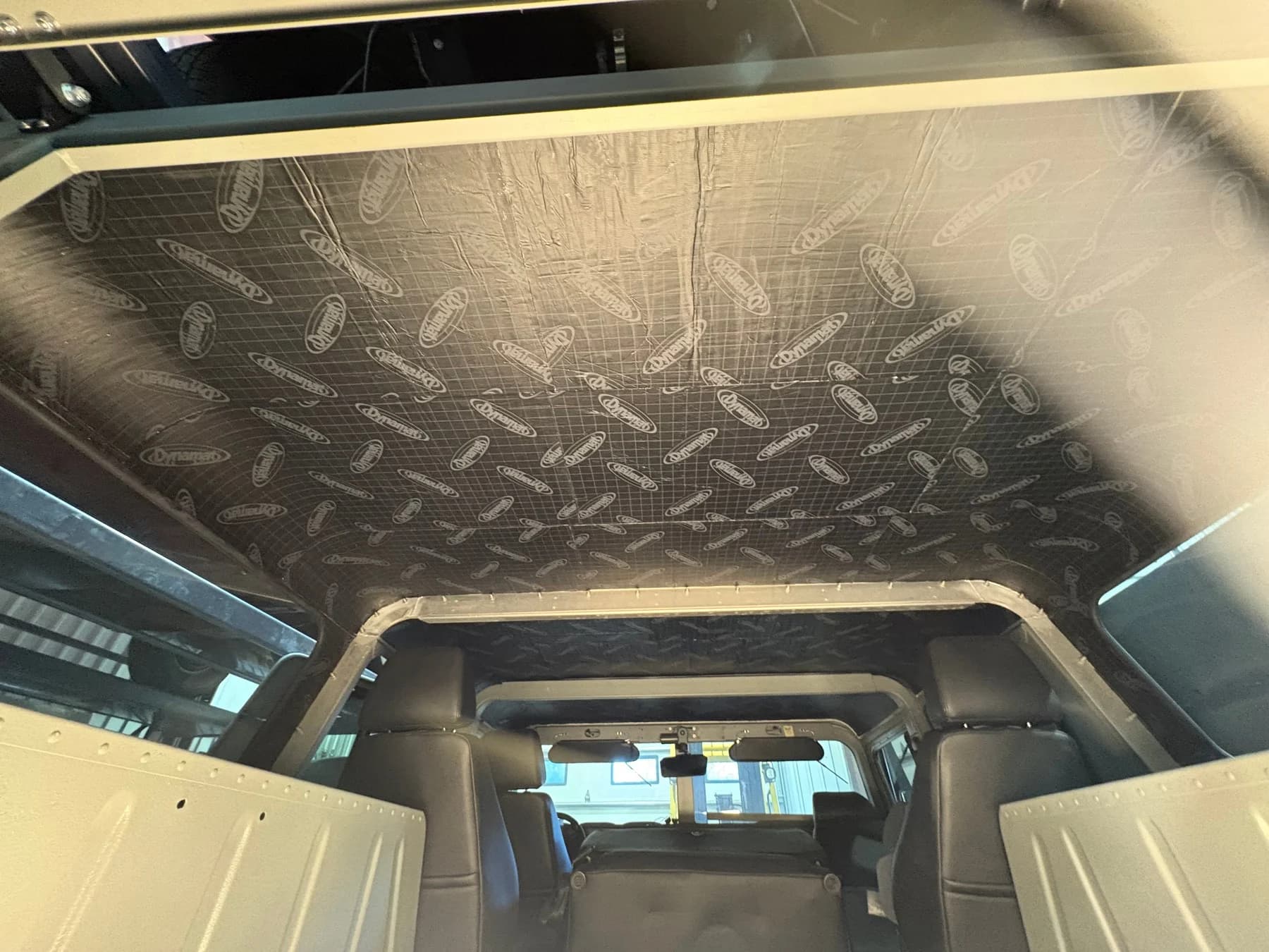 Roof-insulation work in the grey Humvee.