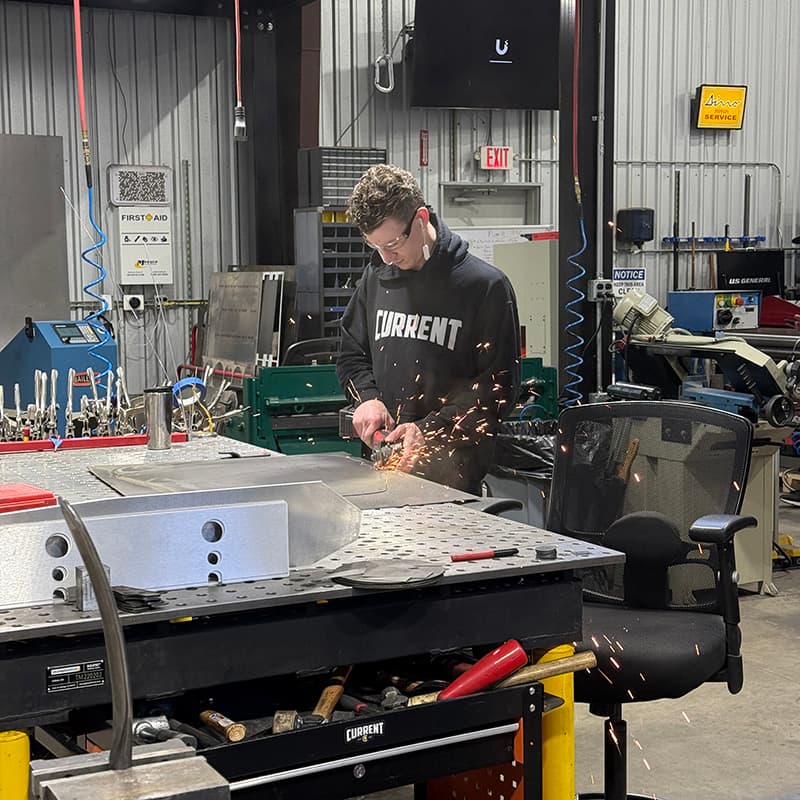 Fabricator grinding metal